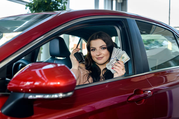 Happy customer holding cash after selling her junk car to Fast Tow in Hammond, IN